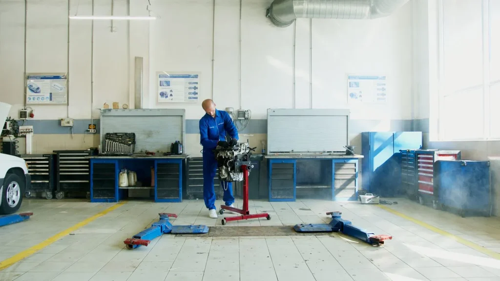 Technician working in a clean, well-equipped auto workshop