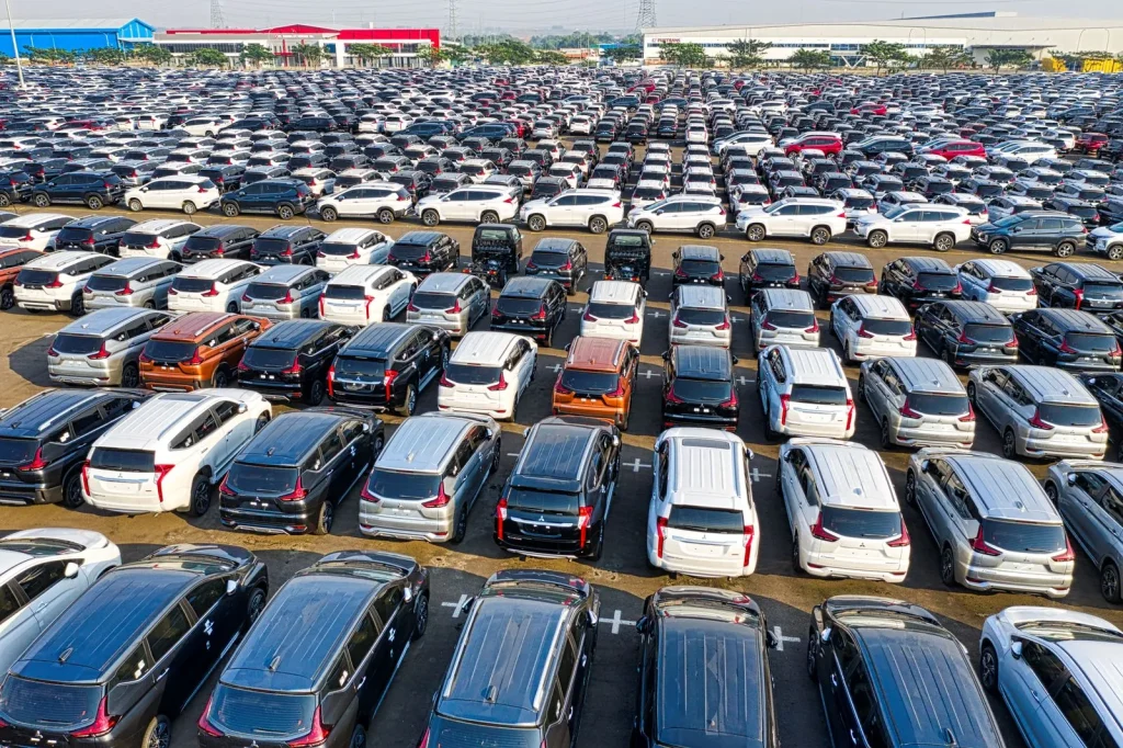 Aerial view of rows of new cars in a large lot