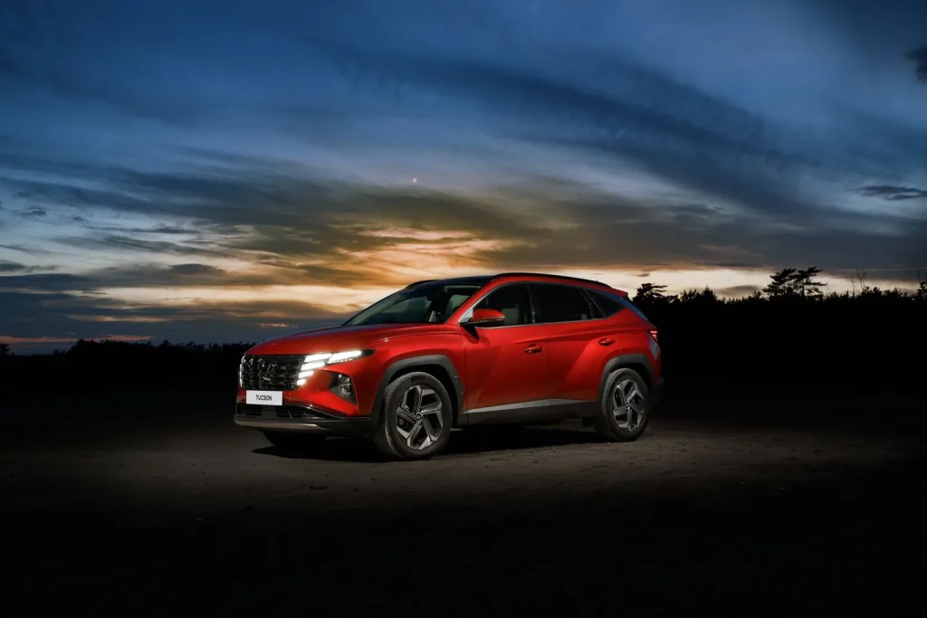 Red Hyundai Tucson parked at dusk