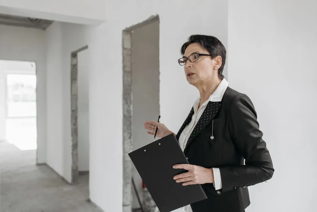 Inspector with a clipboard checking an unfinished building interior
