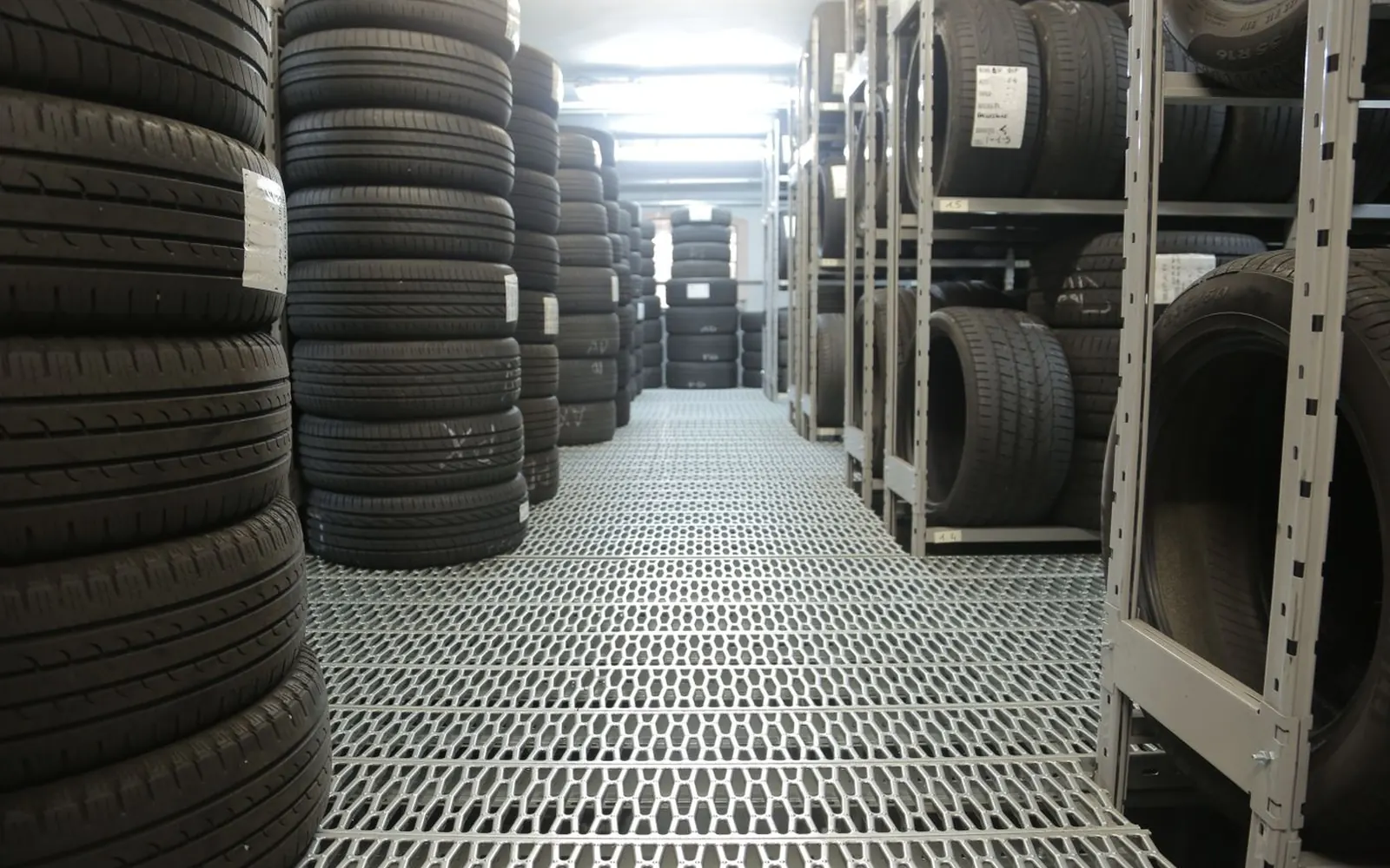 Rows of tyres stored on racks in a tyre warehouse